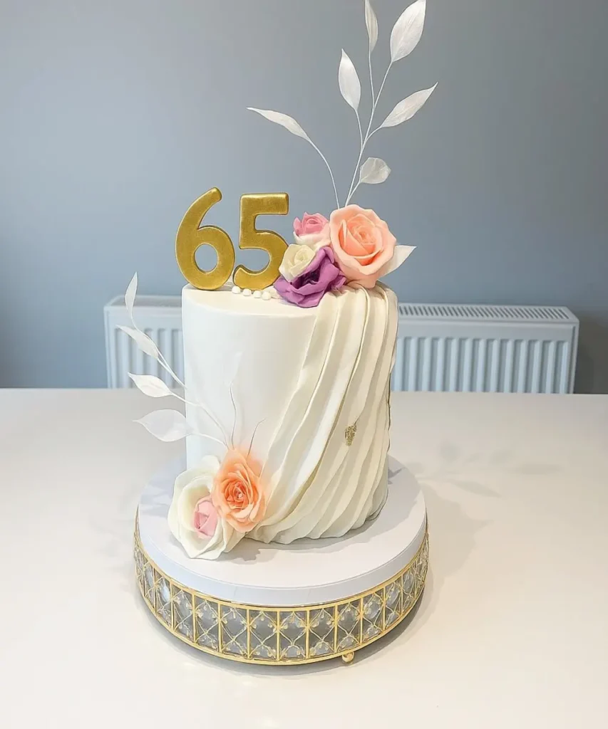 65 year celebration birthday cake with feathers